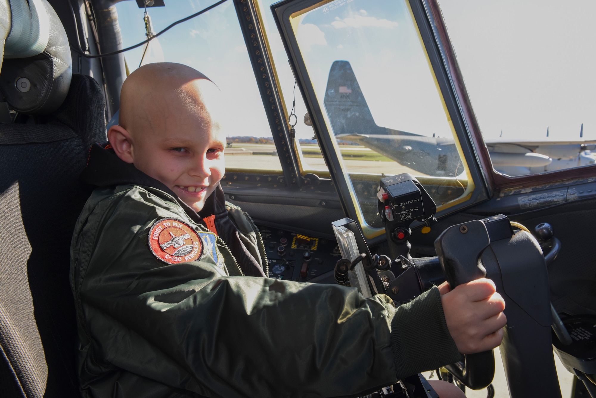 Drew Palmer, an eight-year old battling bone cancer, holds the control wheel of a C-130 Hercules at the Pittsburgh International Airport Air Reserve Station, Pa., Nov. 4, 2015. Palmer was honored as a “Pilot for a Day” and made an honorary Second Lieutenant for the day as he was able to tour the base and see what Airmen of the 911th Airlift Wing do on a daily basis. During his tour, he also visited the Navy Operational Support Center where he was made an honorary Lieutenant Commander. (U.S. Air Force photo by Staff Sgt. Joshua J. Seybert)