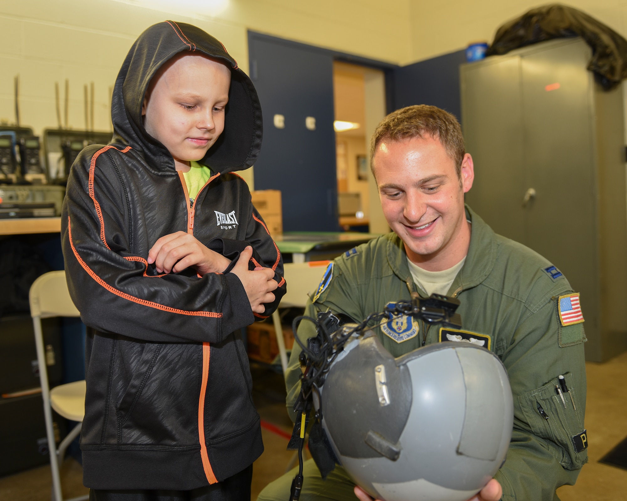 Capt. Charlie Baker, 758th Airlift Squadron pilot, shows Drew Palmer, 911th Airlift Wing Pilot for a Day, an aircrew member helmet at the Pittsburgh International Airport Air Reserve Station, Pa., Nov. 4, 2015. Palmer, who is battling bone cancer, was honored as a “Pilot for a Day” and made an honorary Second Lieutenant before taking a tour of the base and seeing everything that pilots must do before being able to fly. (U.S. Air Force photo by Staff Sgt. Joshua J. Seybert)