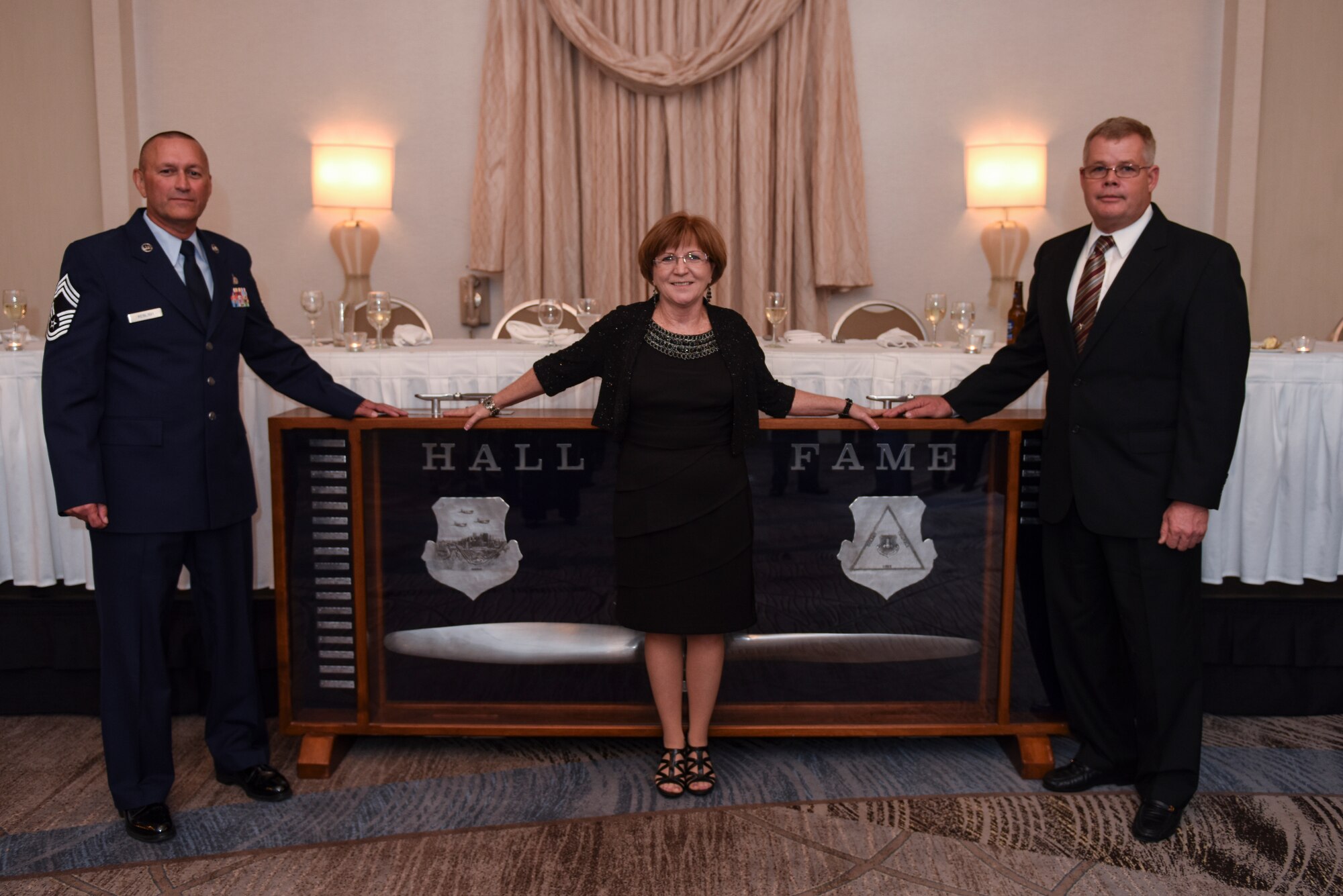 Chief Master Sgt. (Ret.) Terrance J. Keblish, Senior Master Sgt. (Ret.) Barbara Creegan and Chief Master Sgt. (Ret.) James Morgan pose for a photo in front of the 911th Airlift Wing’s Hall of Fame award after an induction ceremony Nov. 7, 2015, in Robinson Twp., Pennsylvania. All three retirees were inducted into the 911th AW Hall of Fame, joining the 21 others previously entered into the hall, which was founded in 1989. The 911th Hall of Fame was created by Chief Master Sgt. (Ret.) John G. Fahrny, Jr. as an avenue by which the 911th AW’s enlisted men and women could recognize a fellow Airman who has been a strong supporter of the enlisted cause. (U.S. Air Force photo by Staff Sgt. Joshua J. Seybert)