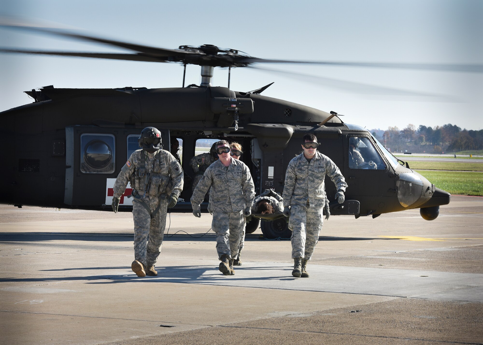 Airmen from the 911th Aeromedical Staging Squadron work with Soldiers from the Pennsylvania Army National Guard’s 1-104th Attack Reconnaissance Battalion to safely unload injured personnel during a training exercise Nov. 8, 2015, at the Pittsburgh International Airport Air Reserve Station. 911th ASTS members trained with the National Guard Soldiers, based out of Johnstown, Pennsylvania, on an engine running on-load/off-load exercise with the Guard’s UH-60 Blackhawk helicopter. (U.S. Air Force photo by Staff Sgt. Justyne Obeldobel)