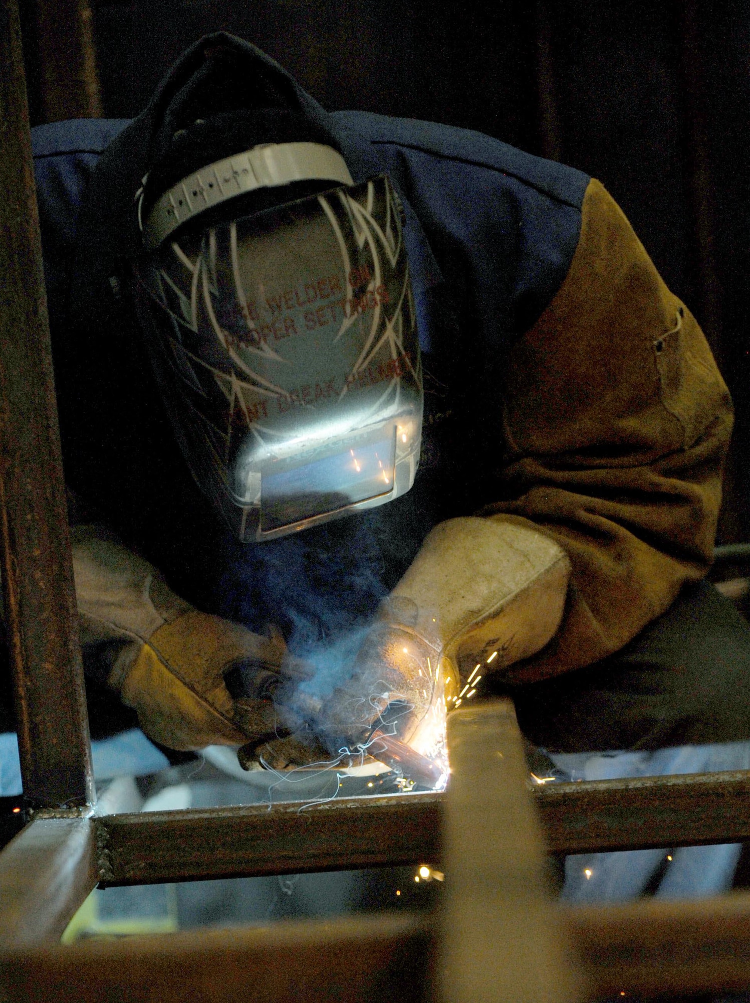 Airman 1st Class Jordan McCollum, 28th Logistics Readiness Squadron vehicle maintenance journeyman, welds two metal bars to create a storage rack for B-1 bomber tires at Ellsworth Air Force Base, S.D., Nov. 3, 2015. The storage rack ensures each $40,000 tire is secured and remains serviceable. (U.S. Air Force photo by Airman Sadie Colbert/Released)