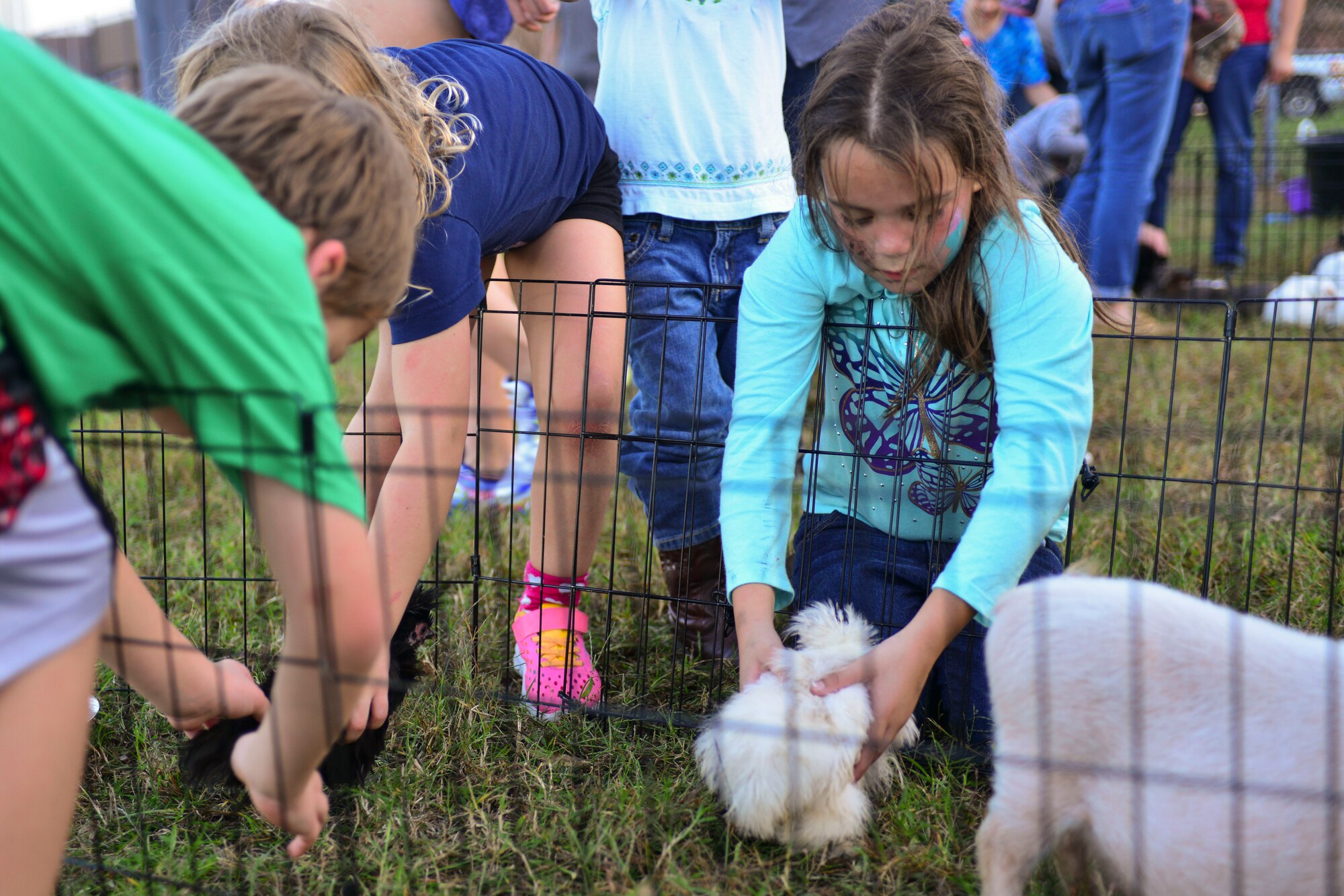 Family members of the 1st and 192nd Fighter Wings play with petting zoo animals during the wings’ homecoming celebration at Langley Air Force Base, Va., Nov. 6, 2015.  The celebration was not only a way to celebrate the U.S. Service members’ homecoming, but also to show appreciation for their families. (U.S. Air Force photo by Tech. Sgt. Katie Gar Ward/Released)