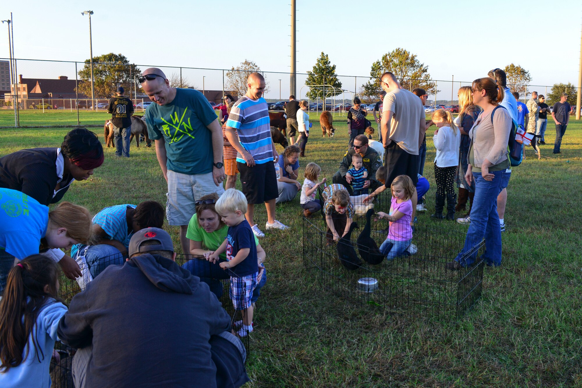 U.S. Service members and families of the 1st and 192nd Fighter Wings play with petting zoo animals during the wings’ homecoming celebration at Langley Air Force Base, Va., Nov. 6, 2015.  The celebration allowed Service members and families from the 1st and 192nd FWs to reunite after a year’s worth of combat missions. (U.S. Air Force photo by Tech. Sgt. Katie Gar Ward/Released)