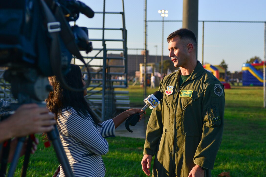 U.S. Air Force Col. Peter Fesler, 1st Fighter Wing commander, speaks with a local news agency during a homecoming celebration at Langley Air Force Base, Va., Nov. 6, 2015. The celebration allowed Service members and their families from the 1st and 192nd Fighter Wings to reunite after a year’s worth of combat missions. (U.S. Air Force photo by Tech. Sgt. Katie Gar Ward/Released)