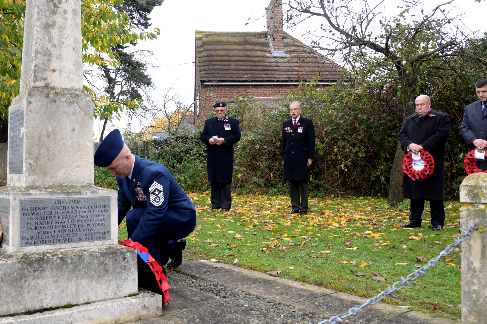 U.S. Air Force Chief Master Sgt. Anthony Cruz Munoz, 100th Air Refueling Wing command chief, lays a wreath at the base of a war memorial during a Remembrance Day ceremony Nov. 8, 2015, in Beck Row, Suffolk, England. Remembrance Day is annually observed in November to commemorate the sacrifices of service members for all armed conflicts. (U.S. Air Force photo by Senior Airman Kate Thornton/Released)