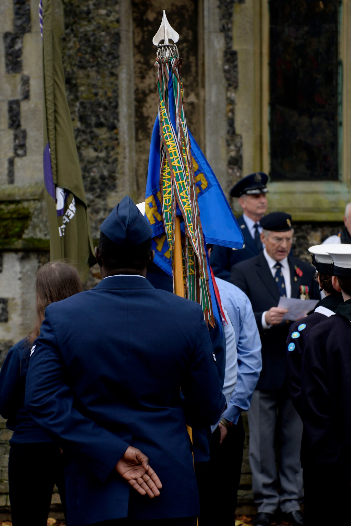 A U.S. Air Force Airman, members of the Royal British Legion and several local scout troops stand at parade rest while names of fallen service members are read during Remembrance Day Nov. 8, 2015, in Dickleburgh, England. Remembrance Day is celebrated annually in November throughout the U.K. to honor the men and women who gave their lives in both World Wars and subsequent conflicts. (U.S. Air Force photo by Senior Airman Victoria H. Taylor/Released)