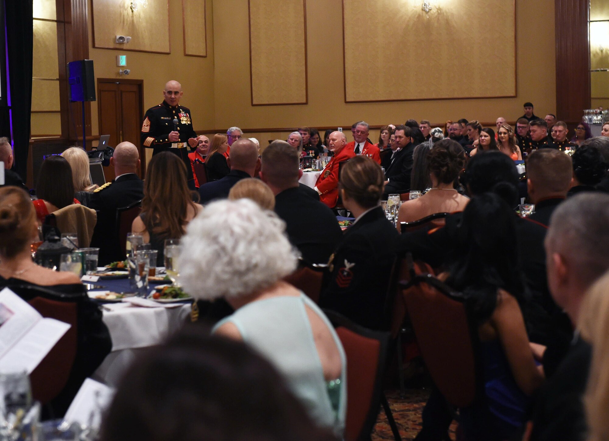 Company A, Marine Cryptologic Support Battalion, Marines and guests listen to Master Gunnery Sgt. Zach Reeves, Marine Corps Detachment Presidio of Monterey senior enlisted advisor, during the Marine Corps Birthday Ball Nov. 6, 2015, at the at the Denver Athletic Club, Denver. The ball was held in honor of the Marine Corps’ 240th birthday, complete with a guest speaker, dinner and dancing. (U.S. Air Force photo by Airman 1st Class Samantha Meadors/Released)