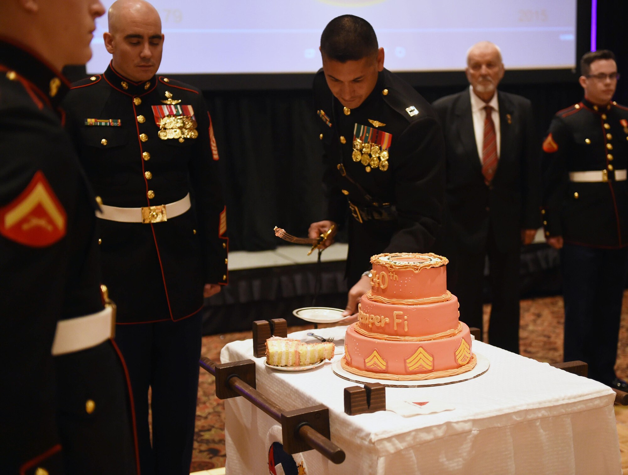 Capt. David Rubio, Company A, Marine Cryptologic Support Battalion commanding officer, cuts the cake during the Marine Corps Birthday Ball Nov. 6, 2015, at the Denver Athletic Club, Denver. The ball was held in honor of the Marine Corps’ 240th birthday, complete with a guest speaker, dinner and dancing. (U.S. Air Force photo by Airman 1st Class Samantha Meadors/Released)