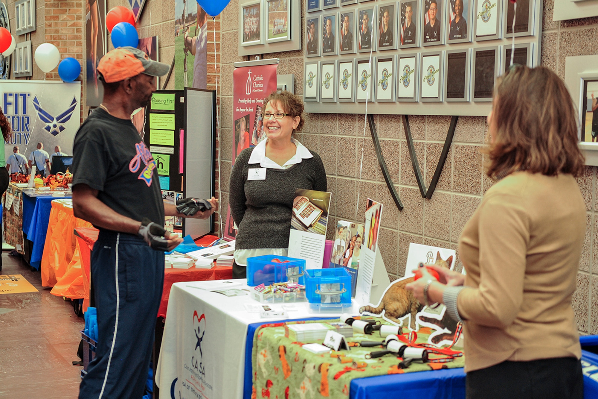 PETERSON AIR FORCE BASE, Colo. – Airmen from Peterson Air Force Base visit booths at a charity fair for the Combined Federal Campaign at the Peterson AFB Fitness Center, Nov. 6, 2015. The charity fair was held in conjunction with a dodgeball tournament. Each booth provided information to help Airmen decide which charity or organization they want to donate to. (U.S. Air Force photo by Philip Carter)