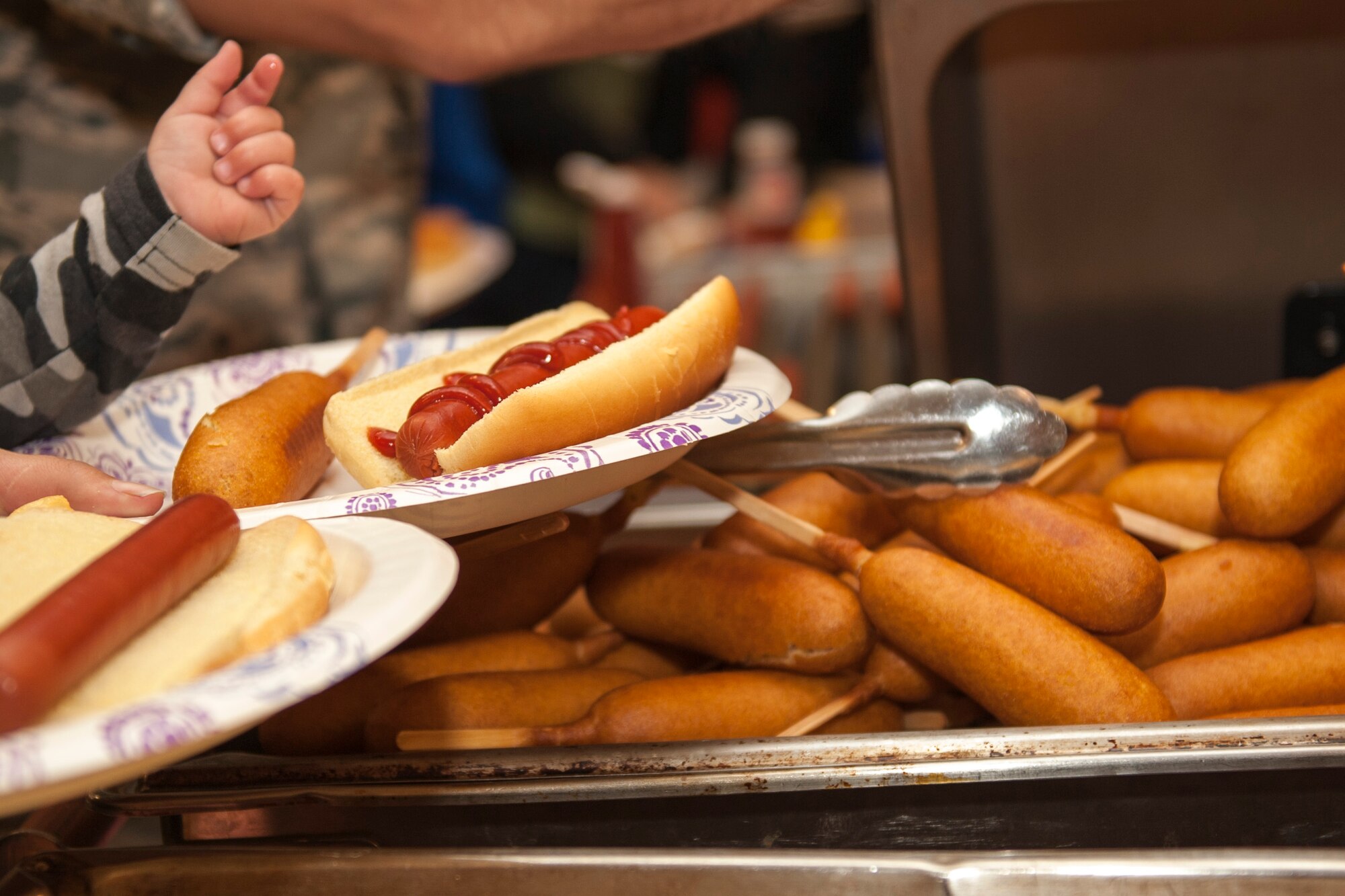 PETERSON AIR FORCE BASE, Colo. - Families passing through the line at the Peterson Chapel's fair food event loaded up with hot dogs and french fries, Nov. 5, 2015. Families enjoyed many types of food found at fairs, including funnel cakes and cotton candy. (U.S. Air Force photo by Senior Airman Rose Gudex)