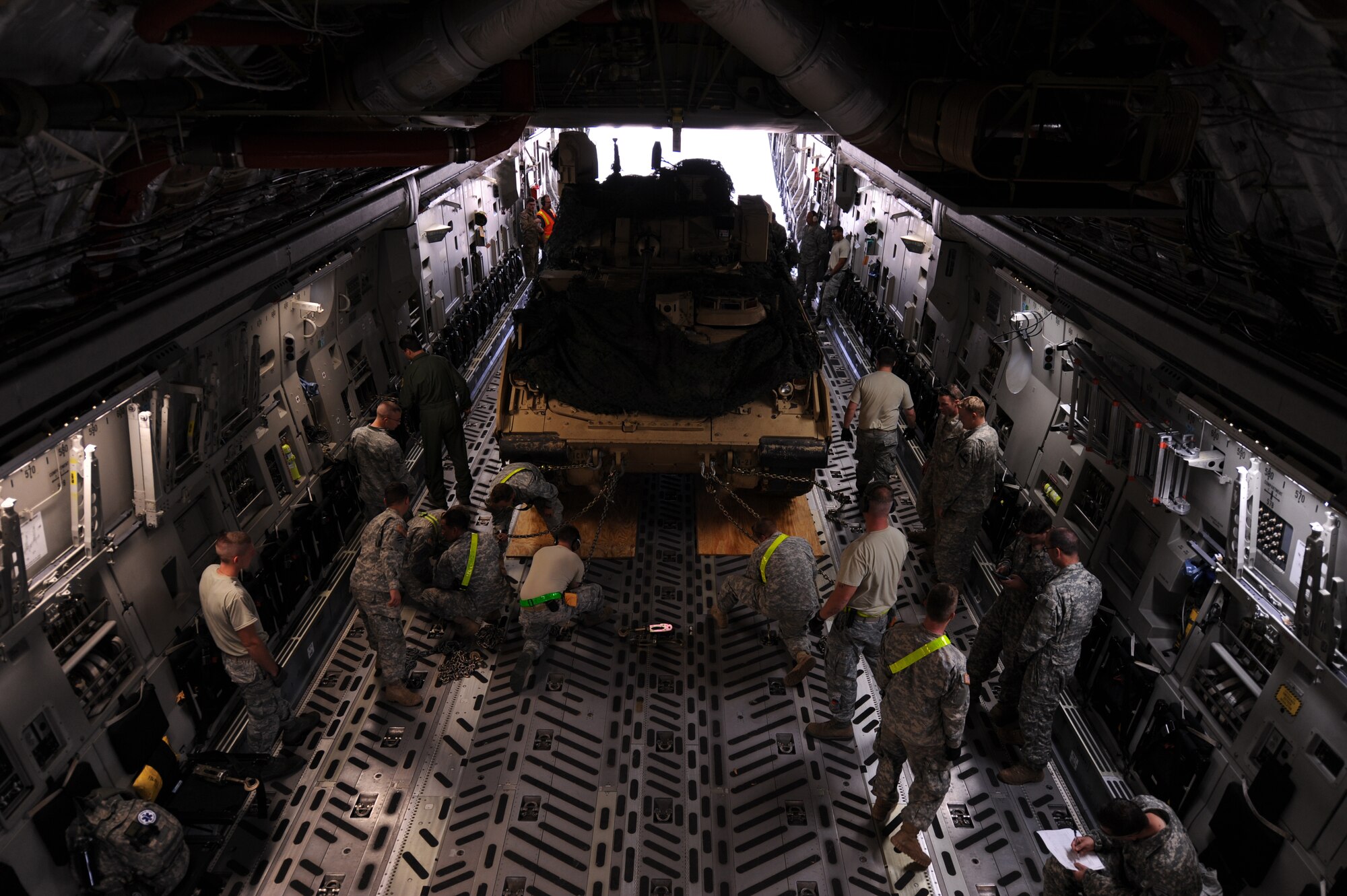Airmen and soldiers participating in GREEN FLAG Little Rock 16-02, secure an M2 Bradley tank to a C-17 Globemaster III Nov. 3, 2015, at Alexandria, La. GFLR is a Mobility Air Force exercise which provides aircrew training in support of Army exercises. (U.S. Air Force photo by Senior Airman Scott Poe)