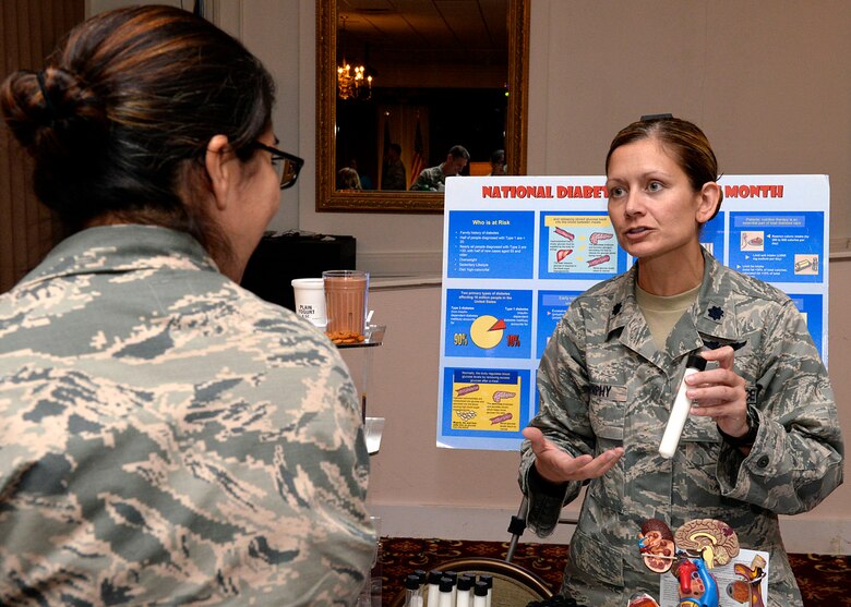 Lt. Col. Theresa Murphy, 66th Medical Squadron health care integrator, speaks about National Diabetes Awareness Month with Staff Sgt. April Castro, 66th Air Base Group NCO in charge chapel operations, and base resident, during a Hanscom Town Hall meeting at the Minuteman Commons Nov. 4. Dozens of people gathered to receive updates about base services, base construction projects, upcoming events, housing and more during the event. (U.S. Air Force photo by Mark Wyatt) 
