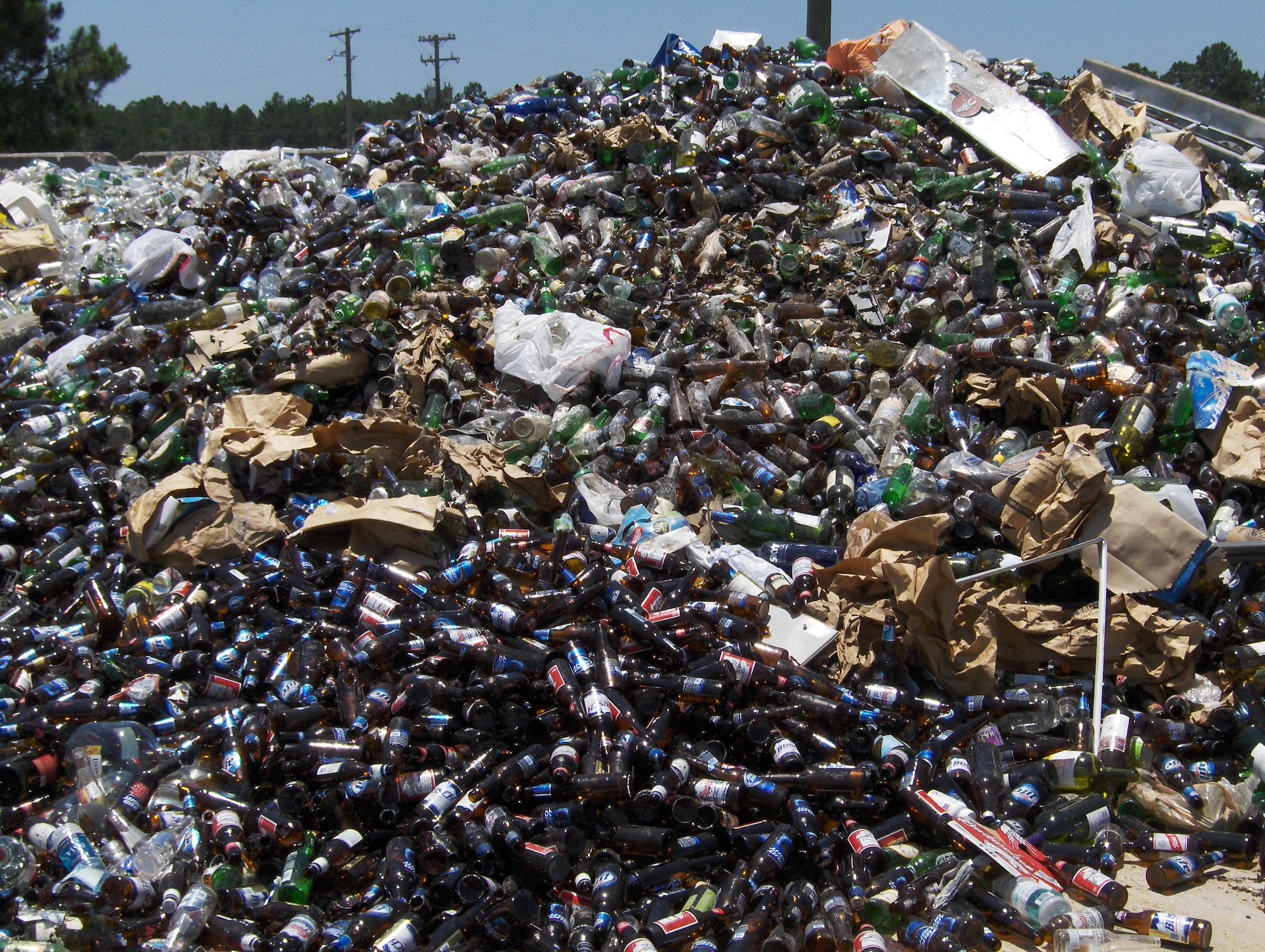 A mountain of glass bottles at the Eglin Recycling Center waits to be sold to the highest bidder. Eglin's Qualified Recycling Program returns all of its profits to  base projects. The center generates approximately $400,000 annually before expenses. (U.S. Air Force photo)
