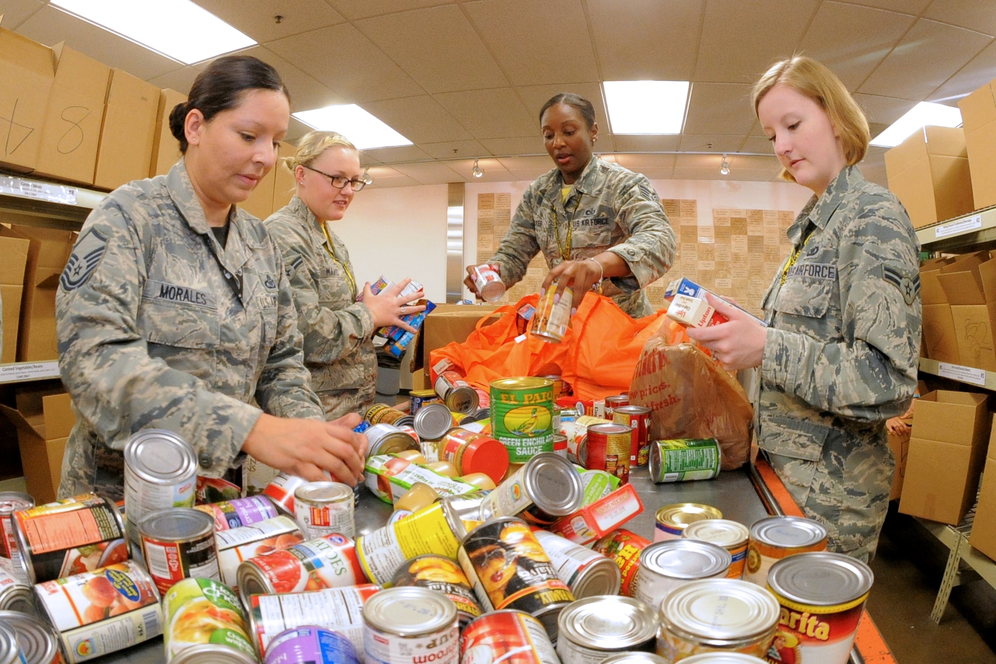 From the left, Master Sgt. Flor Morales, 75th Operations Support Squadron, Airman 1st Class Hannah Maass, Staff Sgt. Lateisha Walker and Airman1st Class Jamie Diaz, all assigned to the 4th Fighter Squadron, sort donated food items at the Utah Food Bank, Salt Lake City, Utah, Friday, Nov. 6, 2015. The Airmen worked with Utah Jazz players and personnel, Orbital ATK executives, other military members and the Utah Food Bank to sort food and pack backpacks with nutritious items for distribution to children in the community. The service project, called “Commitment to Service,” was conducted in honor of Veterans Day. (US Air Force photo by Todd Cromar/Released)