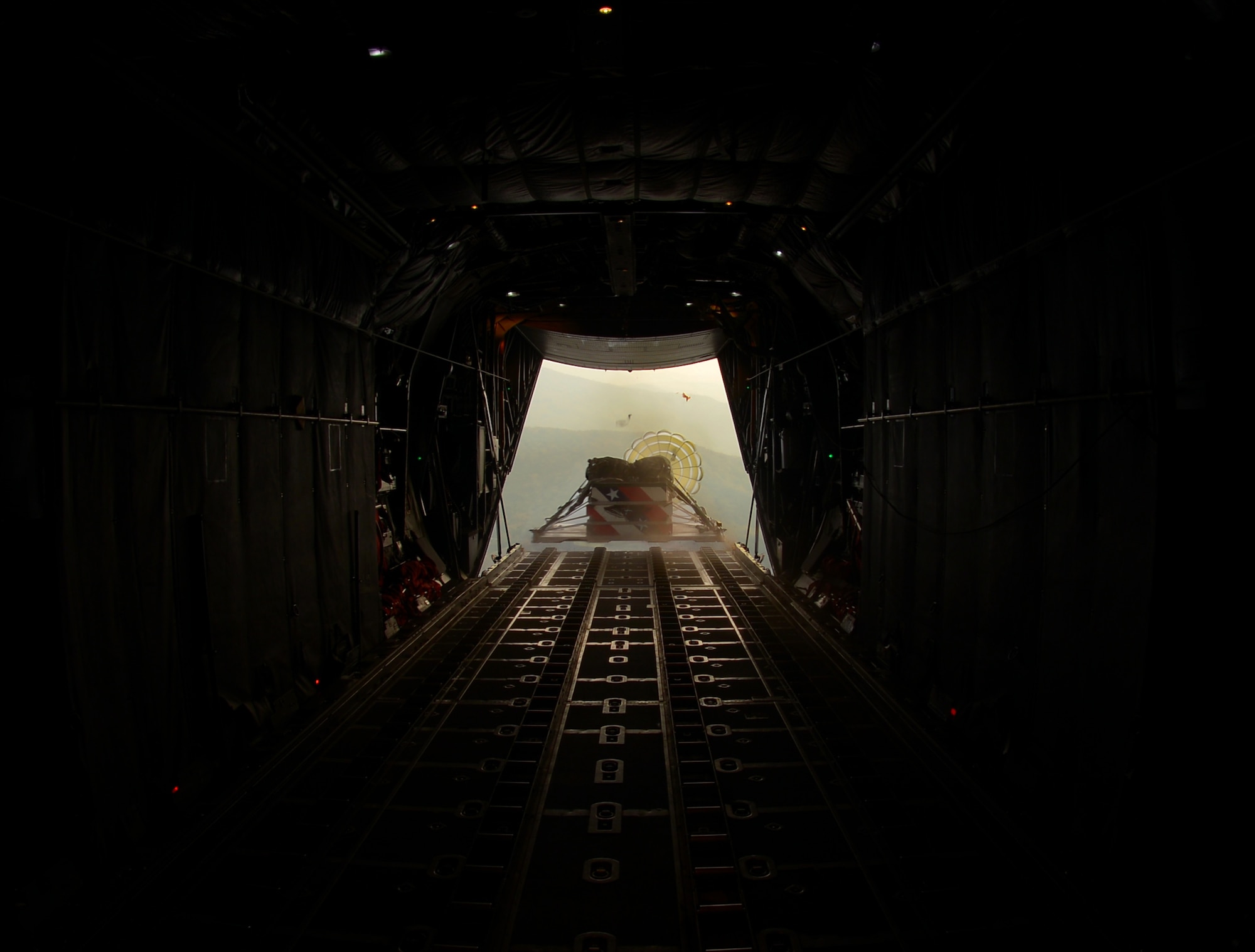 A pallet is released from a C-130 Hercules flying over Korea, Nov. 5, 2015. Pallets can be used to deliver critical supplies, from food to vehicles, during emergencies. The pallet was dropped as part of the wing’s participation in Exercise VIGILANT ACE 16 a U.S.-Republic of Korea combined exercise aimed at enhancing operational and tactical level coordination through combined and joint combat training.  (U.S. Air Force photo by Airman 1st Class Baker/Released)