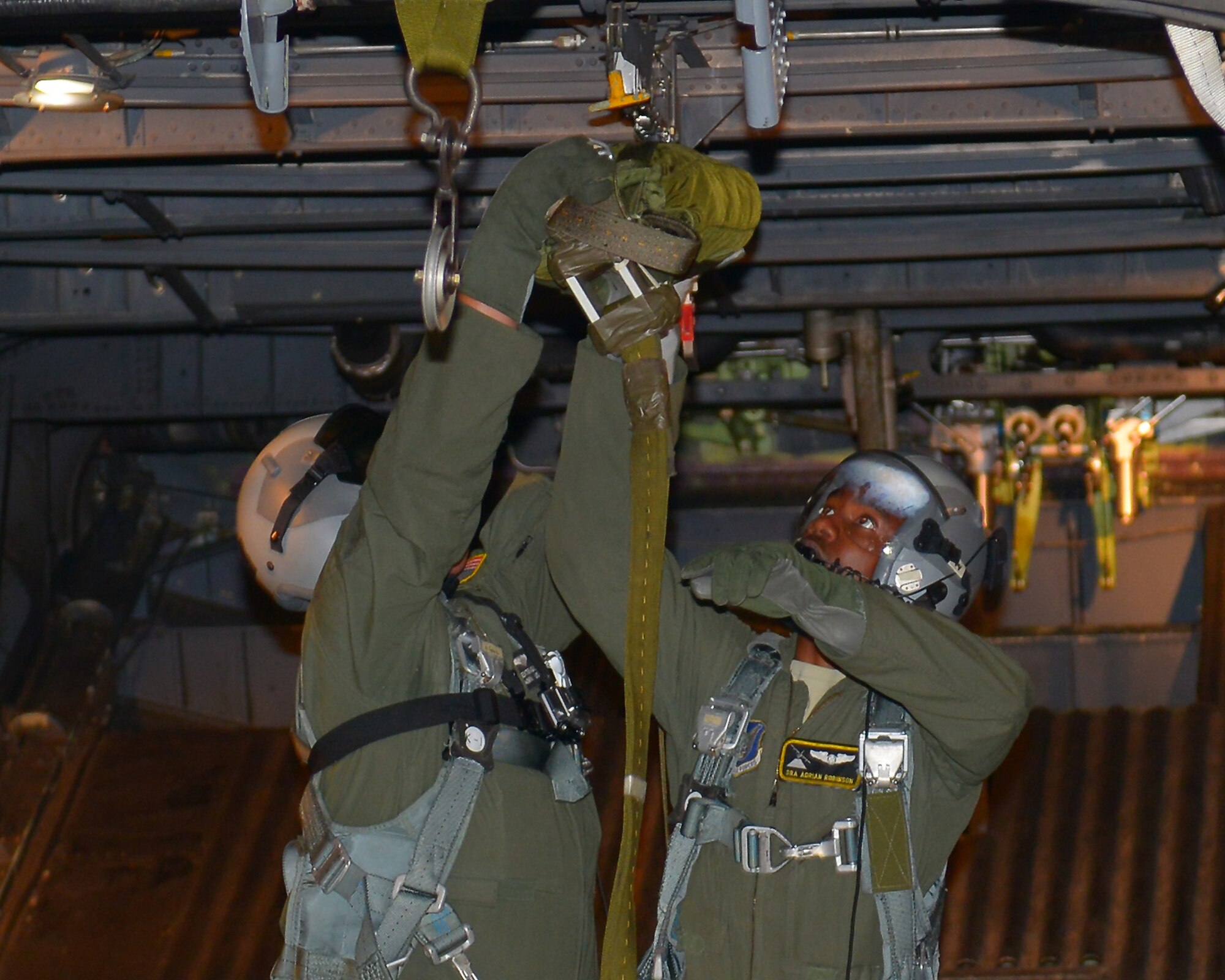 Senior Airman Adrian Robinson and Airman Dexter Lagace, 36th Airlift Wing, loadmasters, ready a pallet to be dropped from a C-130 Hercules flying over Korea, Nov. 5, 2015. Performing air drops helps Yokota Air Base, Japan, maintain proficiency in low-level flying and air drop procedures. The drops were conducted as part of Exercise VIGILANT ACE 16, a U.S.-Republic of Korea combined exercise aimed at enhancing operational and tactical level coordination through combined and joint combat training.  (U.S. Air Force photo by Airman 1st Class Baker/Released)