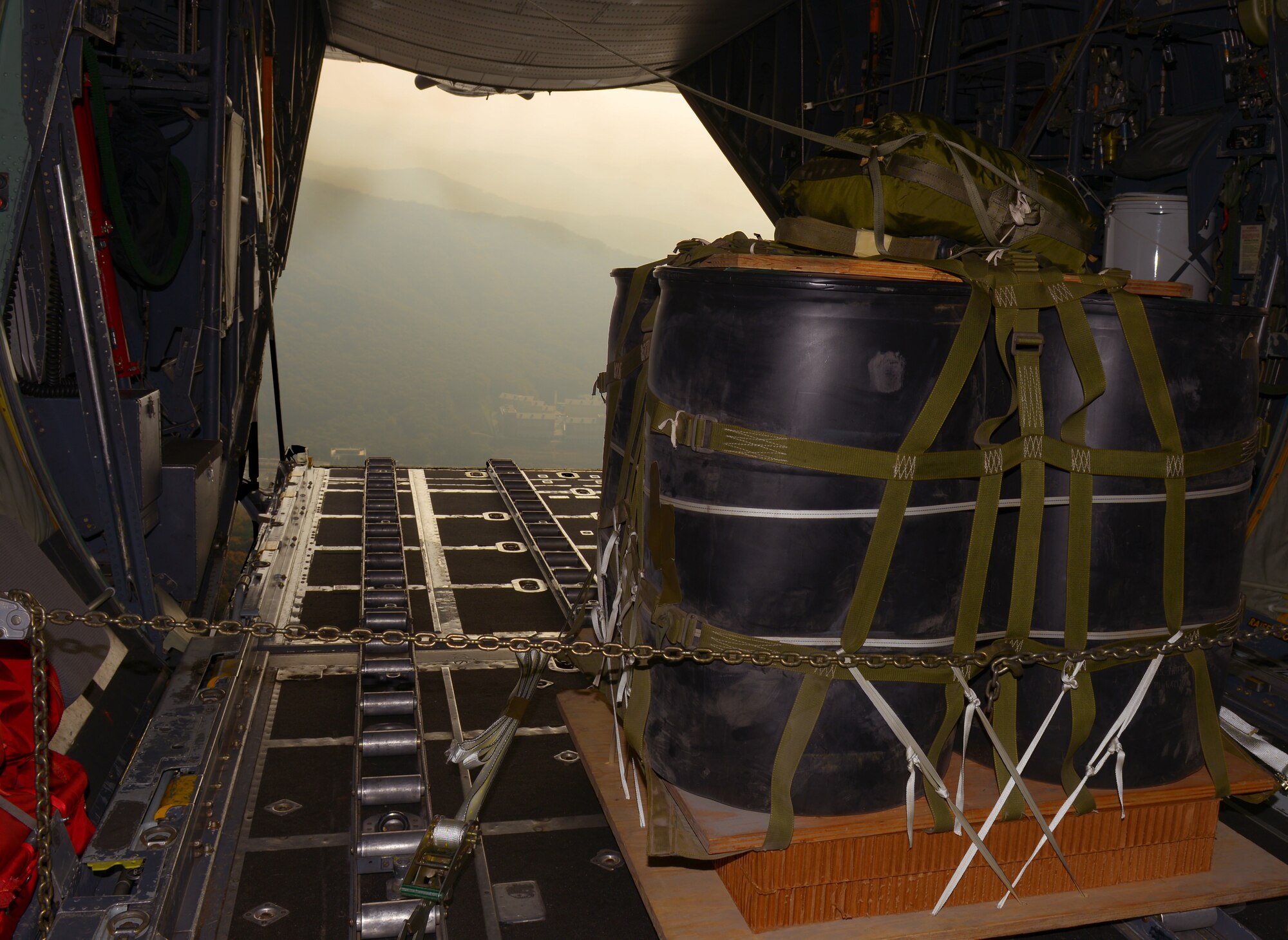 A pallet is prepared to be released from the back of a C-130 Hercules while flying over Korea, Nov. 5, 2015. The 36th Airlift Squadron uses pallets such as this one, called a high-velocity container delivery system, to simulate air drop procedures for supplies. The pallet was dropped as part of the 374th Airlift Wing’s participation in Exercise VIGILANT ACE 16, a U.S.-Republic of Korea combined exercise aimed at enhancing operational and tactical level coordination through combined and joint combat training. (U.S. Air Force photo by Airman 1st Class Baker/Released)