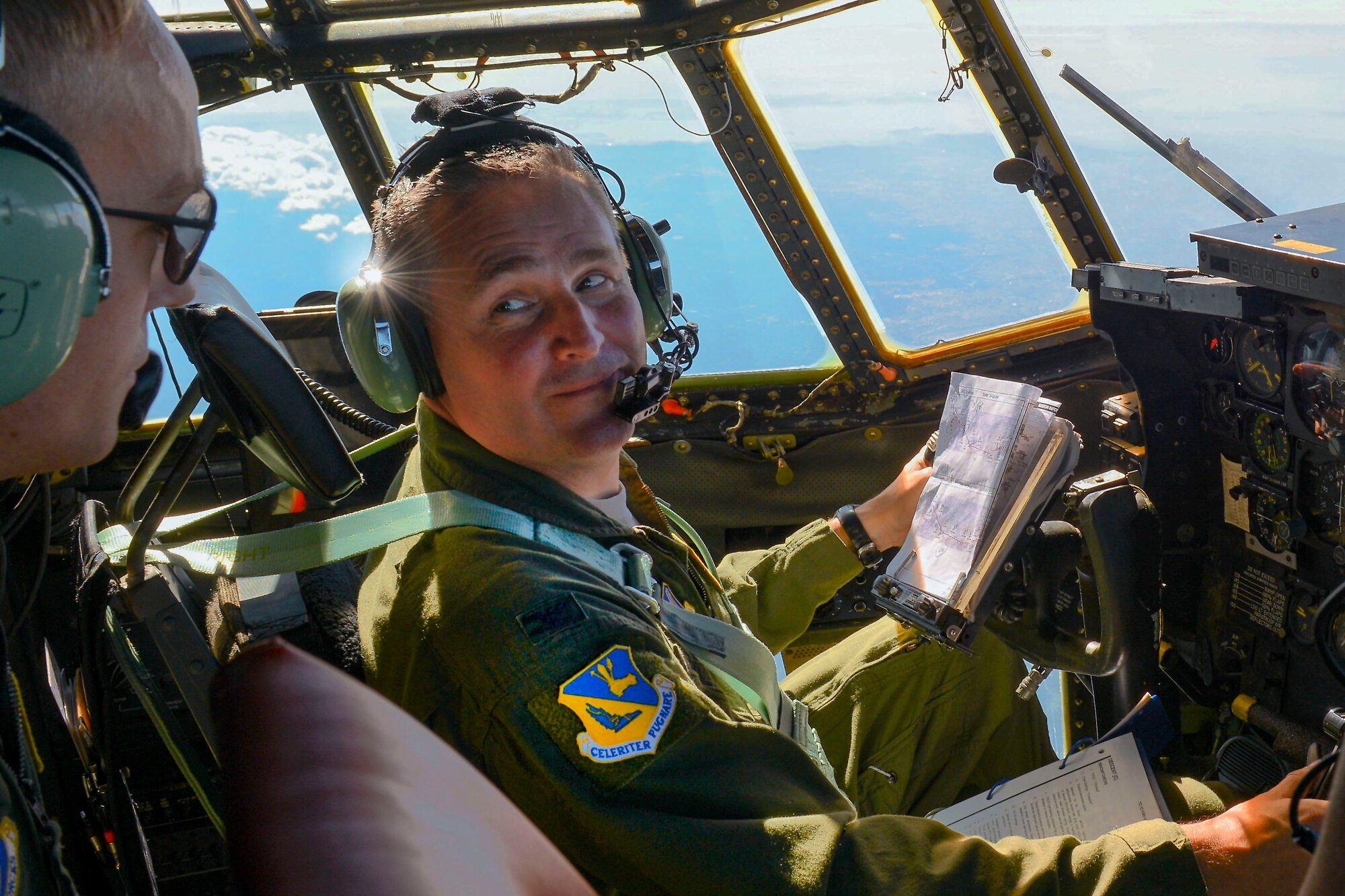 Col. Douglas DeLaMater, 374th Airlift Wing commander, communicates with his flight engineer, Tech. Sgt. Travis Livingston with the 36th Airlift Squadron, while flying a C-130 Hercules over Japan, Nov. 5, 2015. DeLaMater participated in a pallet drop as part of the Wing’s participation in Exercise VIGILANT ACE 16, a U.S.-Republic of Korea combined exercise aimed at enhancing operational and tactical level coordination through combined and joint combat training. (U.S. Air Force photo by Airman 1st Class Baker/Released)