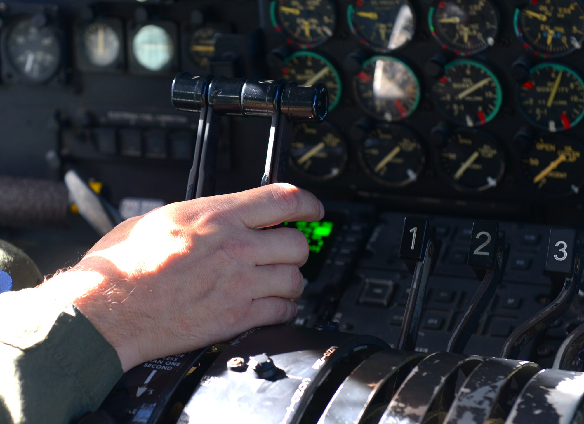 Col. Douglas DeLaMater, 374th Airlift Wing commander, adjusts the throttle of a C-130 Hercules while flying over Japan, Nov. 5, 2015. DeLaMater flew the aircraft over Korea to perform a pallet drop as part of the wing’s participation in Exercise VIGILANT ACE 16. During the deployment phase of the exercise, the 374 AW conducted 42 missions, generated 87 sorties, totaling over 250 flying hours, and moved more than 400 thousand pounds and more than 650 passengers.  (U.S. Air Force photo by Airman 1st Class Baker/Released)