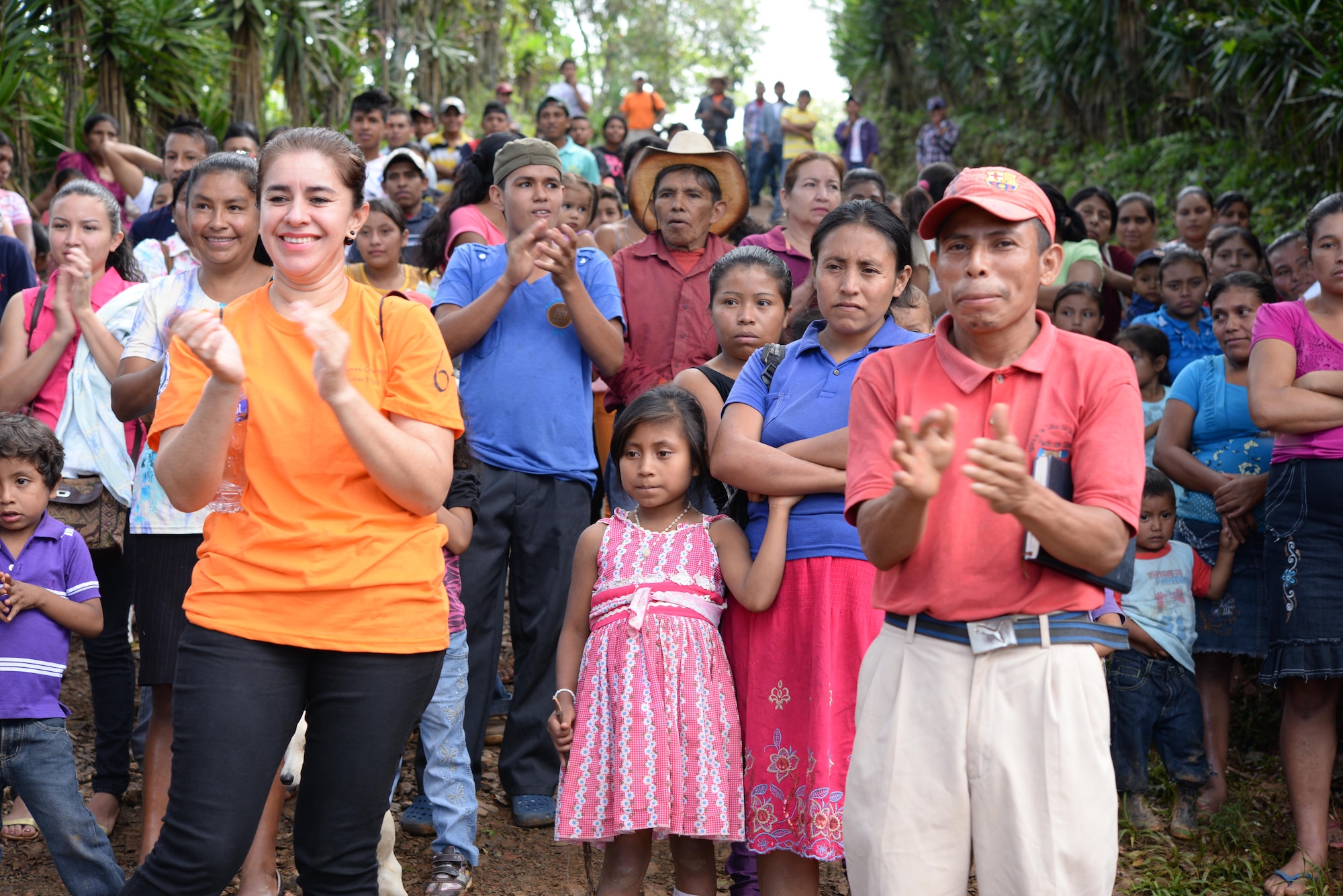 Locals from Las Moras, Comayagua, Honduras, applaud U.S. military members and civilians as they finish hiking in food and supplies during Chapel Hike 64, Oct. 31, 2015. Chapel Hikes take place every six weeks and provide community outreach by bringing much needed food and supplies to the less fortunate. (U.S. Air Force photo by Senior Airman Westin Warburton/Released)