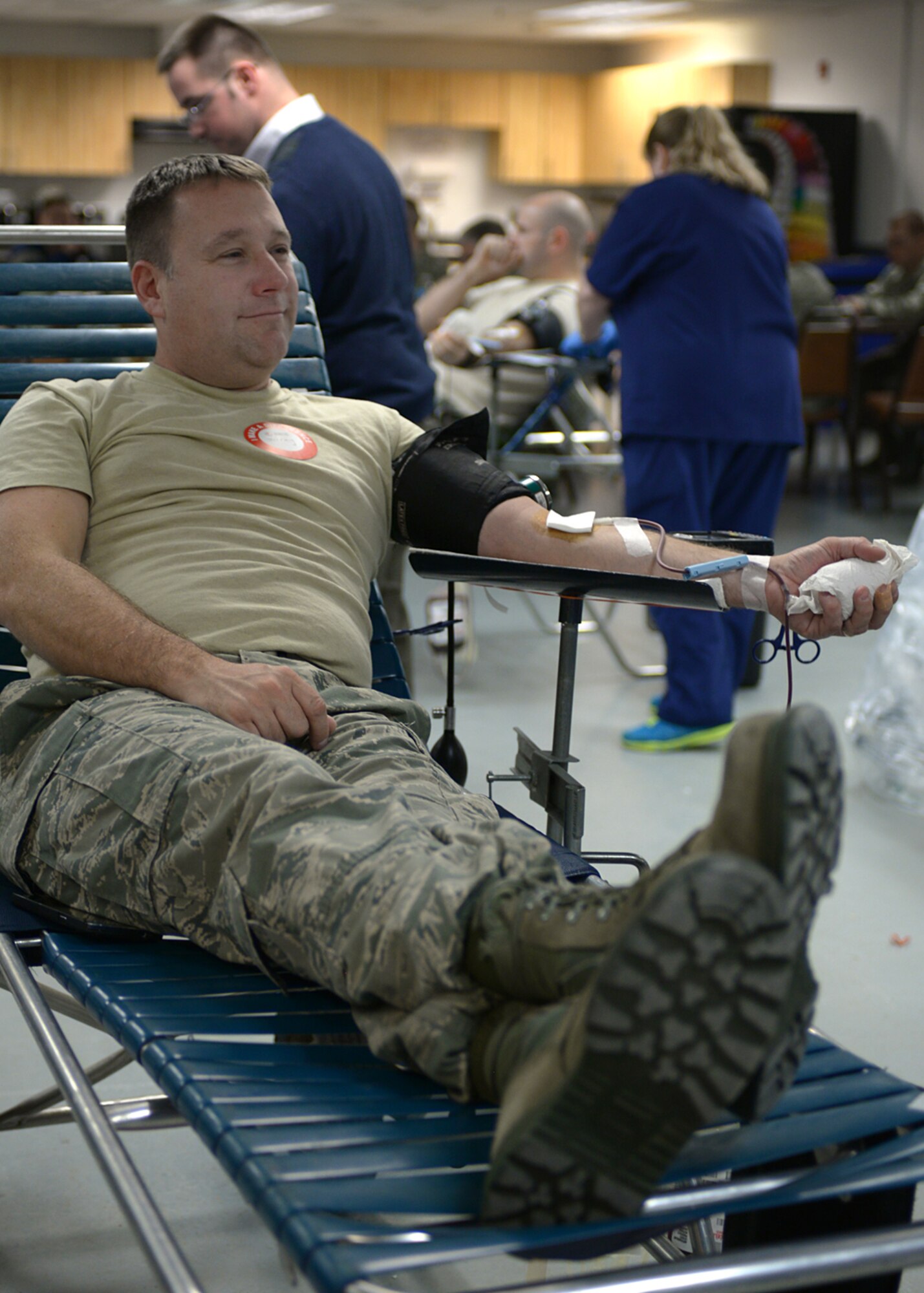 Senior Master Sgt. Jeremy Mercier, 157th Air Refueling Wing Small Air Terminal superintendent, donates blood during a blood drive on base Nov. 7, 2015. The blood drive, which was held in Hanger 254, was a community project the Pease Rising Five professional development group. (U.S. Air National Guard photo by Airman 1st Class Ashlyn J. Correia)