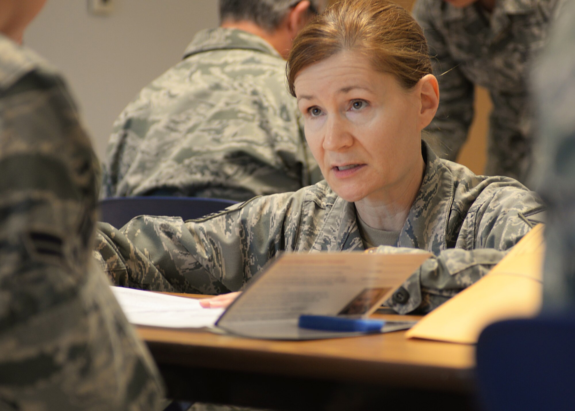 Master Sgt. June Fonteyne, 157th Medical Group health systems technician, explains the bone marrow registration process to an Airman at the clinic Nov. 7, 2015. The drive was run through the C.W. Bill Young Department of Defense Marrow Donor Program, also known as the Salute to Life. (U.S. Air National Guard photo by Staff Sgt. Kayla Rorick) 