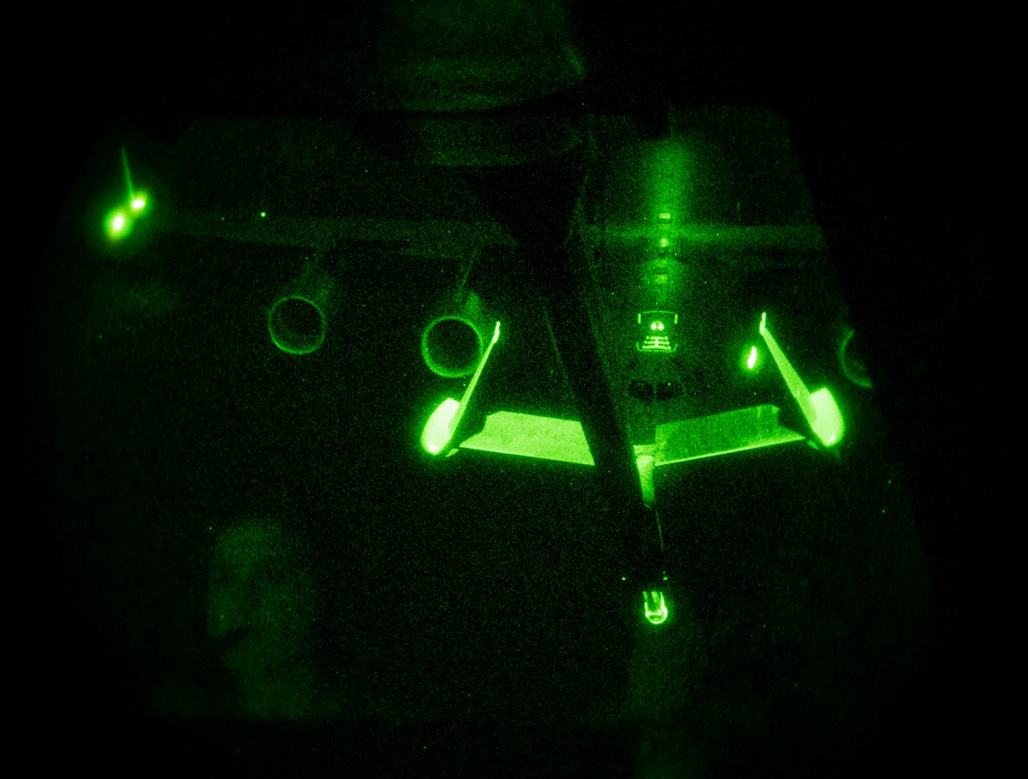 A reflection of U.S. Air Force Airman 1st Class Amy James, 32nd Air Refueling Squadron boom operator, is shown while she refuels a C-17 Globemaster III over the Atlantic Ocean during Trident Juncture 2015, Nov. 3, 2015. Without the refueling capability of the KC-10, the C-17s would not have enough fuel to make it all the way to Spain from the U.S. (U.S. Air Force photo by Staff Sgt. Douglas Ellis/released)