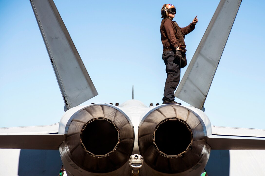 U.S. Navy Airman Mariah Ftacek performs a turnaround check on an F/A-18E Super Hornet on the flight deck of the aircraft carrier USS George Washington in the Atlantic Ocean, Nov. 7, 2015. The George Washington is deployed for Southern Seas 2015. The exercise enhances interoperability, increases regional stability, builds and maintains regional relationships with countries in the region. U.S. Navy photo by Petty Officer 3rd Class Bryan Mai