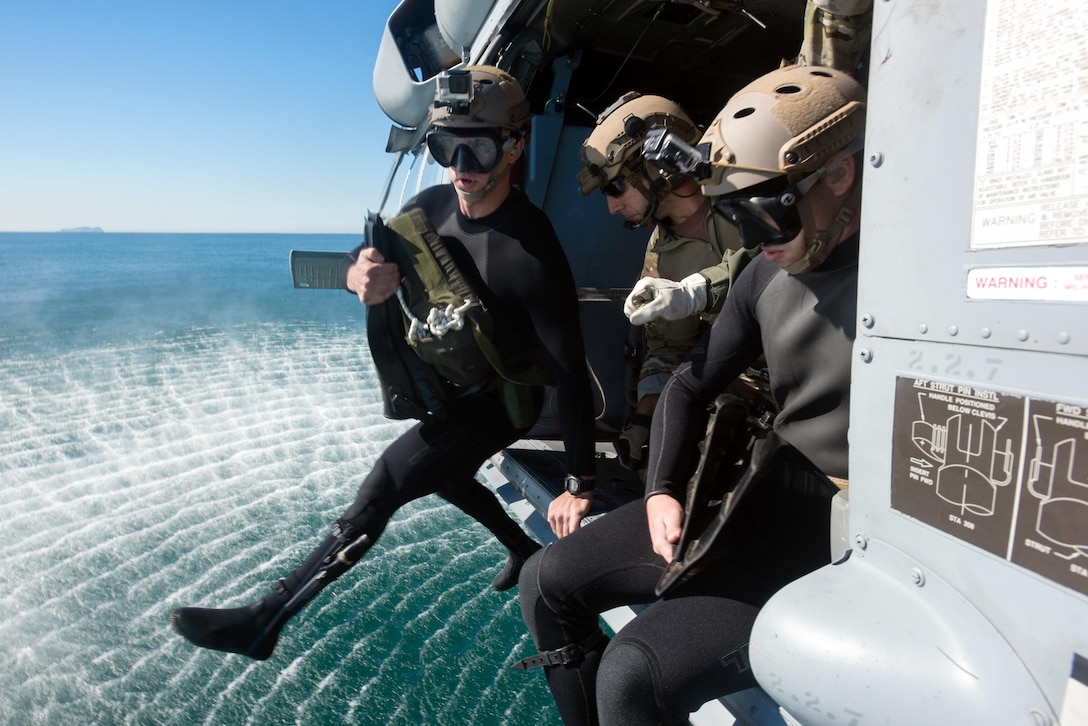 U.S. Navy Petty Officer 2nd Class Jacob Marshall jumps into the ocean from an MH-60S Sea Hawk to place an explosive charge onto a mine-like object in the Pacific Ocean, Nov. 6, 2016. The sailors assigned to the Chargers of Helicopter Sea Combat Squadron 14, are participating in a sustainment training exercise with the John C. Stennis Strike Group. U.S. Navy photo by Petty Officer 3rd Class Kenneth Rodriguez Santiago