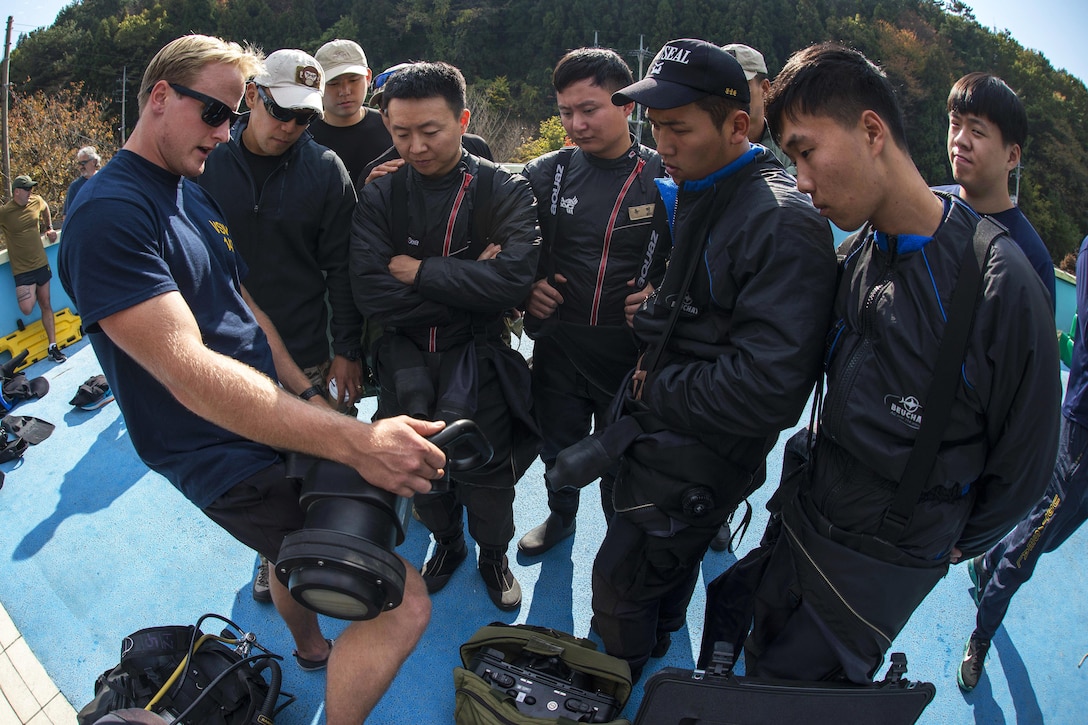 U.S. Navy photo by Petty Officer 3rd Class Aaron Ainley, left, explains the functions of the DNS-300 underwater sonar system to South Korean navy SEALs during Exercise Clear Horizon 2015 on Commander Fleet Activities Chinhae, South Korea, Nov. 5, 2015. Ainley is an explosive ordnance disposal technician assigned to Mobile Unit 1. The annual exercise between the U.S. and South Korean navies focuses on increasing capabilities between ships, and on mine countermeasures in international waters surrounding the Korean peninsula. U.S. Navy photo by Petty Officer 2nd Class Daniel Rolston
