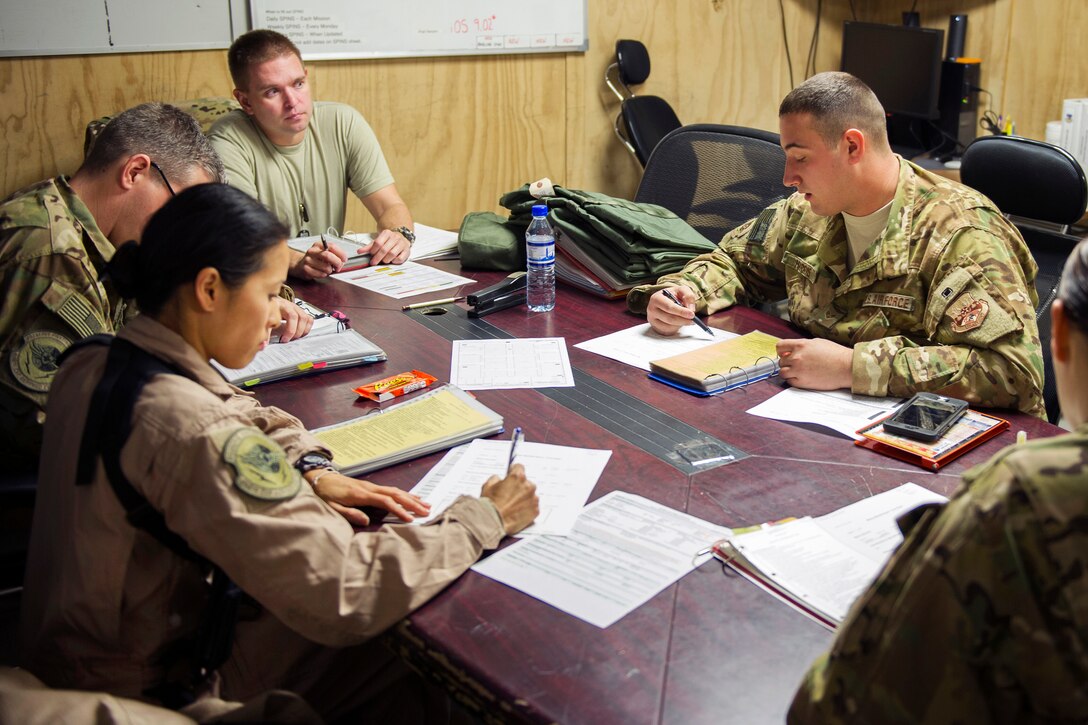 U.S. Air Force Senior Airman Justin Harris, right, gives a charge medical technician brief before departing for an alert mission on Bagram Airfield, Afghanistan, Nov. 6, 2015. Harris is a medical technician assigned to the 455th Expeditionary Aeromedical Evacuation Squadron. The briefing ensures medical team members understand their roles when setting up equipment and ensures safety on the aircraft. U.S. Air Force photo by Tech. Sgt. Robert Cloys