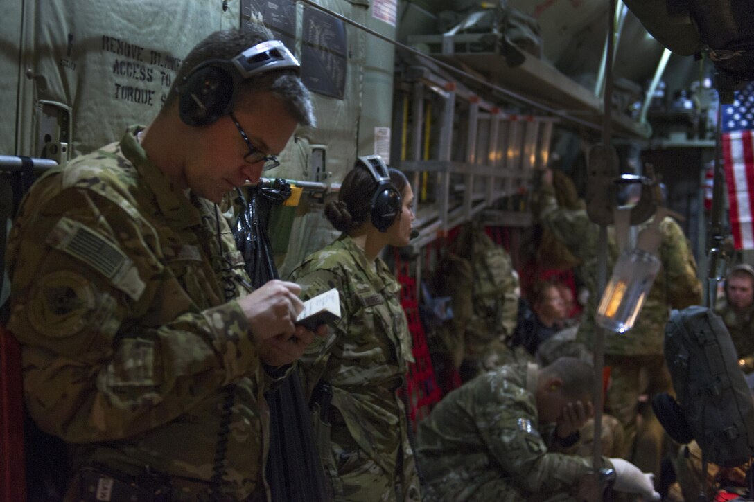 U.S. Air Force Capt. Steven Woods, left, records patient notes during a medevac mission en-route to Al Udeid Air Base, Qatar, from Bagram Airfield, Afghanistan, Nov. 6, 2015. Woods is a flight nurse assigned to the 455th Expeditionary Aeromedical Evacuation Squadron. U.S. Air Force photo by Tech. Sgt. Robert Cloys