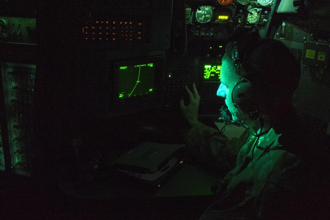 U.S. Air Force 1st Lt. James Gillie monitors his equipment aboard a C-130 Hercules aircraft during an aeromedical evacuation flight from Bagram Airfield, Afghanistan, to Al Udeid Air Base, Qatar, Nov. 6, 2015. Gillie is a flight navigator assigned to the 746th Expeditionary Airlift Squadron. The flight was in support of the 455th Expeditionary Evacuation Squadron, out of Bagram, who are tasked with moving injured and sick patients to locations with higher levels of medical care. U.S. Air Force photo by Tech. Sgt. Robert Cloys