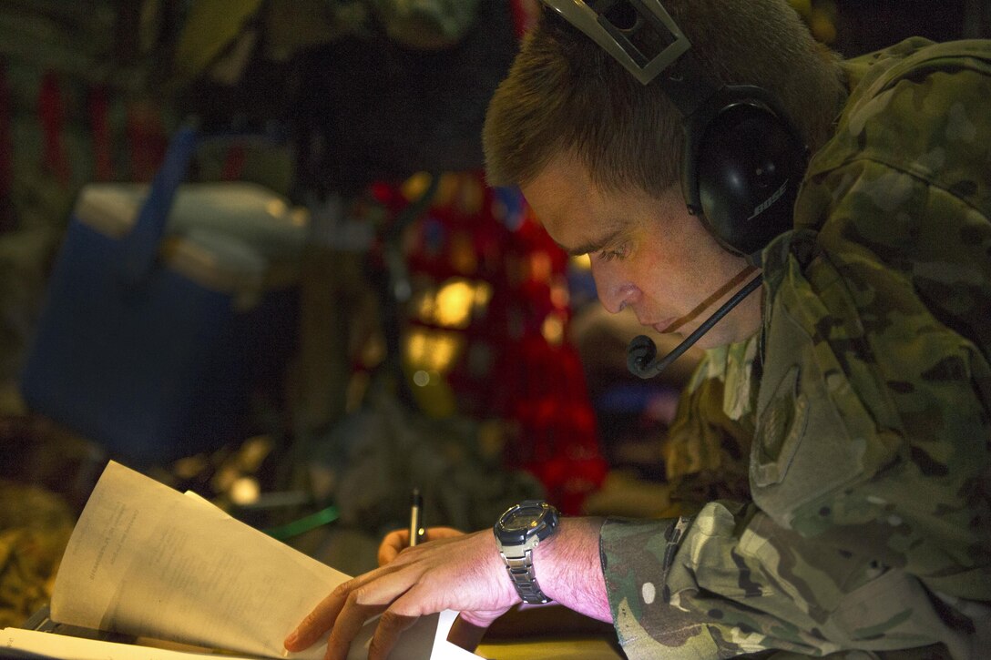 U.S. Air Force Maj. Jim Appel fills out paperwork during a aeromedical evacuation mission en-route to Al Udeid Air Base, Qatar, from Bagram Airfield, Afghanistan, Nov. 6, 2015. Appel is a flight nurse and medical crew director assigned to the 455th Expeditionary Aeromedical Evacuation Squadron. U.S. Air Force photo by Tech. Sgt. Robert Cloys