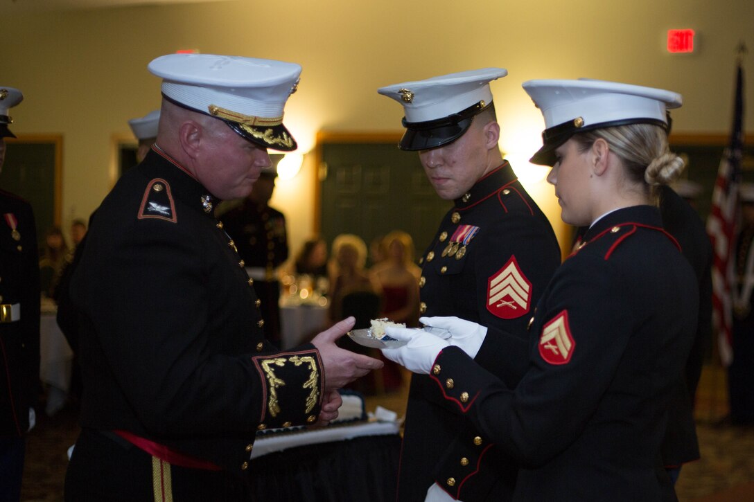 Corporal Logan E. Block, youngest Marine receives a piece of cake from Col. Terence Trenchard, oldest Marine during the ceremony at the Marine Corps Ball at the Great Wolf Lodge in Williamsburg, VA November 7, 2015. Traditionally, the first piece of cake is given to the oldest Marine, then passed on to the youngest Marine. Colonel Trenchard serves as the chief of staff at Marine Corps Recruiting Command and Cpl. Block serves as a Public Affairs Marine at MCRC. 