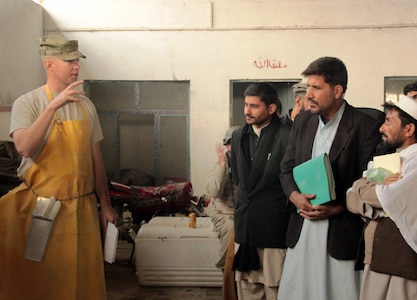 Army National Guard Maj. Samuel Forester, executive officer of the Missouri Agribusiness Development Team, leads an instructional seminar for Afghan government officials on meat inspection in Nangarhar province, Afghanistan. Forester is also a U.S. Department of Agriculture certified meat inspector and his main goal was to show agricultural officials how to work with available resources to educate farmers and commercial butchers on good sanitation practices and animal health.