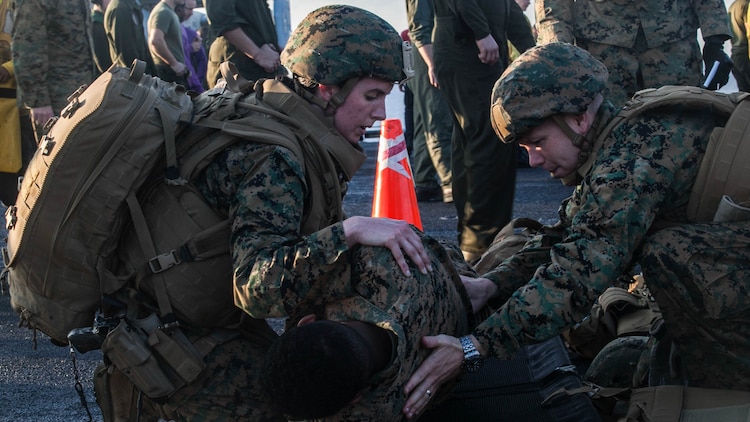 Navy Lt. Katherine Gervais, left, and Lt. Cdr. Brian Dimmer with tend to a simulated causality during a mass-casualty drill on the flight deck of the USS Essex (LHD 2). Gervais is a en-route care nurse assigned to Combat Logistics Battalion 15, and Dimmer is the 15th Marine Expeditionary Unit surgeon. The Marines and Sailors honed their skills to become quicker and more efficient should a situation arise where medical attention is needed. The 15th MEU is currently deployed in the Indo-Asia-Pacific region to promote regional stability and security in the U.S. 7th Fleet area of operations. 