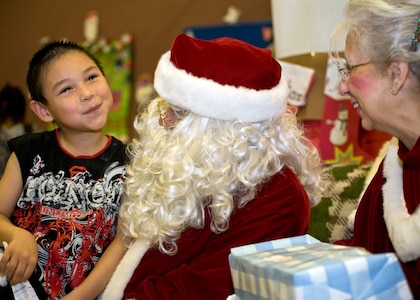 David Anungazuk, 7, visits with Santa and Mrs. Claus, in Wales, Dec. 9, 2011. The Clauses, along with about 35 volunteers from Anchorage, were in Wales for an Operation Santa Claus mission in coordination with the Alaska National Guard.