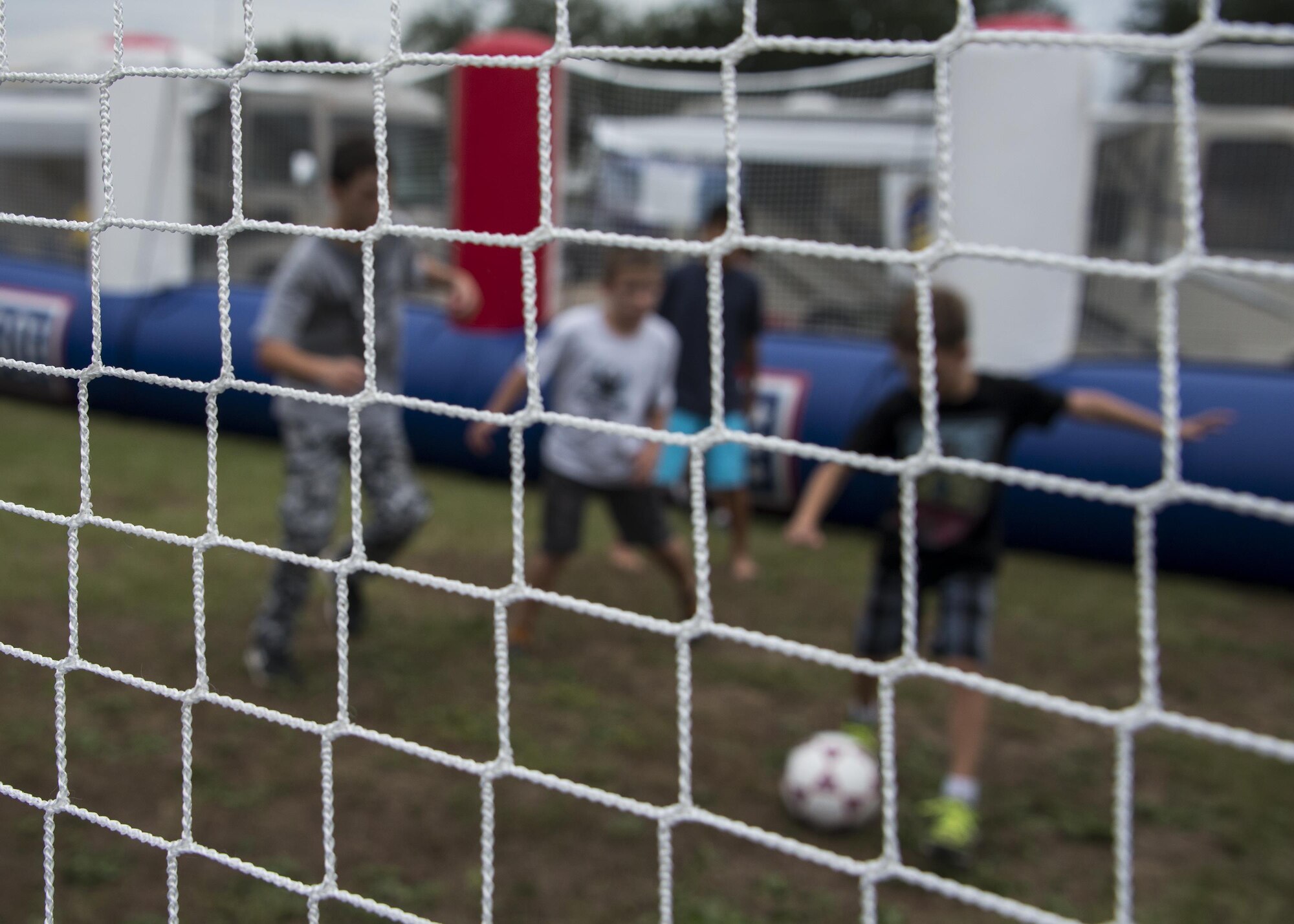 Family members of the 919th Special Operations Wing play soccer in an inflatable soccer field during the Duke Field Wing Day event Nov. 7.  The 919th SOW sets aside a special day each year to show appreciation for its reservists and their family members. Events included music, sports, children’s games, etc. (U.S. Air Force photo/Tech. Sgt. Jasmin Taylor)