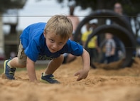 Gavin Sutphen low crawls through the obstacle course during the Duke Field Wing Day event Nov. 7.  The 919th Special Operations Wing sets aside a special day each year to show appreciation for its reservists and their family members. Events included music, sports, children’s games, etc. (U.S. Air Force photo/Tech. Sgt. Jasmin Taylor)
