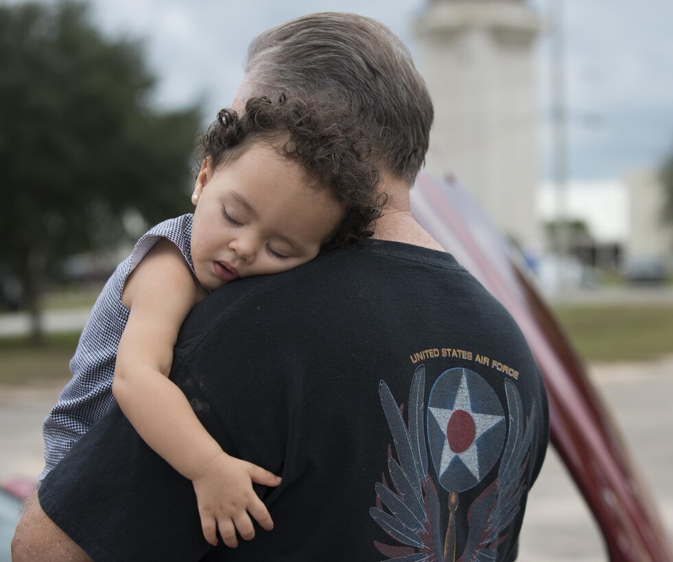Bella Howell takes a nap on her grandfather’s shoulder during the Duke Field Wing Day event Nov. 7.  The 919th Special Operations Wing sets aside a special day each year to show appreciation for its reservists and their family members. Events included music, sports, children’s games, etc. (U.S. Air Force photo/Tech. Sgt. Jasmin Taylor)