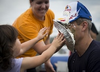 Peyton Roszkowski throws a pie in Col. Robert Bruckner, 919th Special Operations Wing Vice commander during the Duke Field Wing Day event Nov. 7.  The 919th SOW sets aside a special day each year to show appreciation for its reservists and their family members. Events included music, sports, children’s games, etc. (U.S. Air Force photo/Tech. Sgt. Jasmin Taylor)