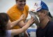 Peyton Roszkowski throws a pie in Col. Robert Bruckner, 919th Special Operations Wing Vice commander during the Duke Field Wing Day event Nov. 7.  The 919th SOW sets aside a special day each year to show appreciation for its reservists and their family members. Events included music, sports, children’s games, etc. (U.S. Air Force photo/Tech. Sgt. Jasmin Taylor)