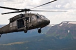 Army Chief Warrant Officer 3 Jonathan Licuanan and Army Chief Warrant Officer 3 Ryan Mahany take turns piloting a UH-60 Black Hawk helicopter in the Rocky Mountains of Colorado, while following the directions of their instructor pilot, Colorado Army National Guard Chief Warrant Officer 4 Mark Grayson, Aug. 25, 2011. Licuanan and Mahany are students at the Colorado National Guard's High-altitude Army National Guard Aviation Training Site in Gypsum, Colo.