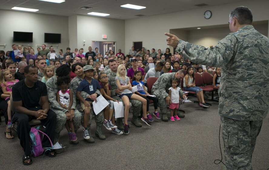 Col. James Phillips, 919th Special Operations Wing commander, talks to the new mock deplorer’s during the Duke Field Operation Hero event Nov. 7. The event was a mock deployment exercise for 919th SOW children. The exercise started with the kids receiving orders before deploying to the 919th Special Operations Logistics Readiness Squadron building. The “little deplorer’s” were issued fake military ID cards, dog tags, and immunizations. (U.S. Air Force photo/ Tech. Sgt. Jasmin Taylor)