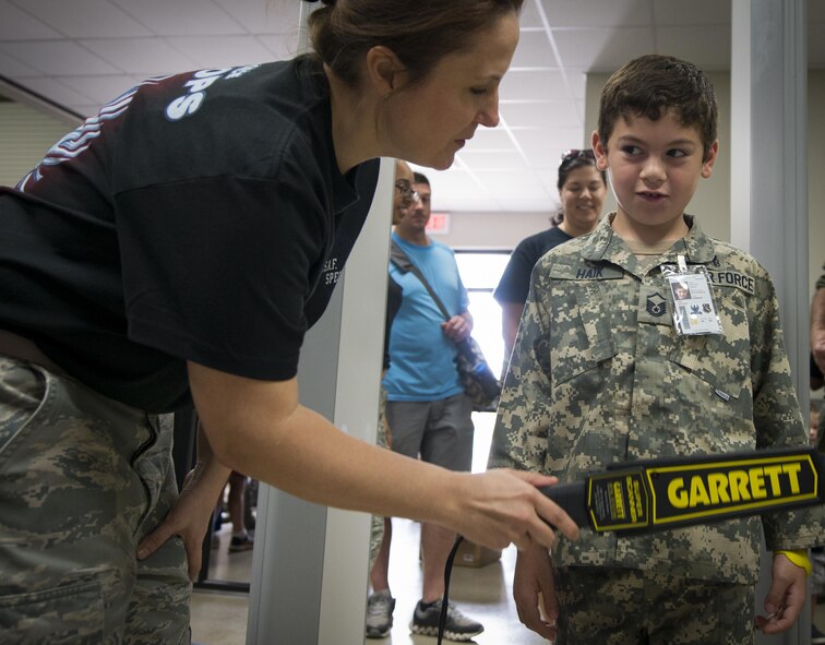 Matthew Haik passes through the security checkpoint during the Duke Field Operation Hero event Nov. 7. The event was a mock deployment exercise for 919th Special Operations Wing children. The exercise started with the kids receiving orders before deploying to the 919th Special Operations Logistics Readiness Squadron building. The “little deployers” were issued fake military ID cards, dog tags, and immunizations. (U.S. Air Force photo/ Tech. Sgt. Jasmin Taylor)