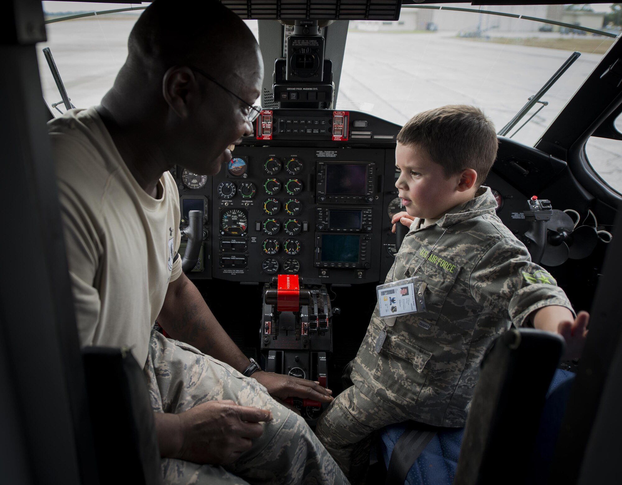 Tech. Sgt. Sedrick Dottin, 919th Special Operations Aircraft Maintenance Squadron, and Kekoa Lee tours a C-145 during the Duke Field Operation Hero event Nov. 7. The event was a mock deployment exercise for 919th Special Operations Wing children. The exercise started with the kids receiving orders before deploying to the 919th Special Operations Logistics Readiness Squadron building. The “little deployers” were issued fake military ID cards, dog tags, and immunizations. (U.S. Air Force photo/ Tech. Sgt. Jasmin Taylor)