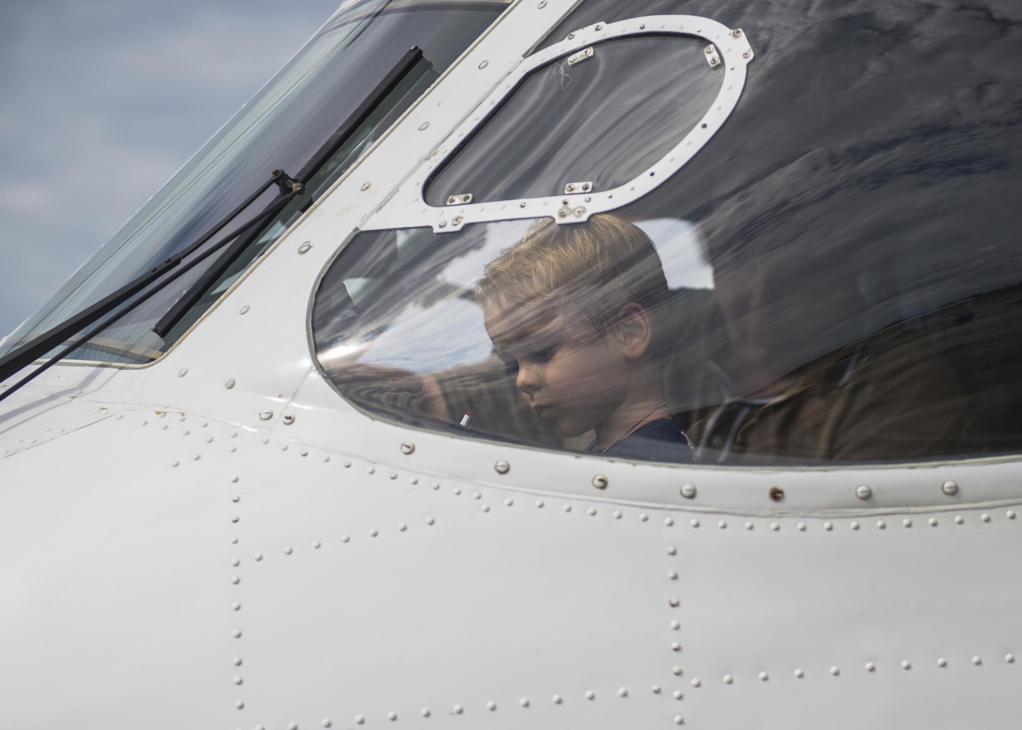 A “Future Airman” simulates flight on a C-145 during the Duke Field Operation Hero event Nov. 7. The event was a mock deployment exercise for 919th Special Operations Wing children. The exercise started with the kids receiving orders before deploying to the 919th Special Operations Logistics Readiness Squadron building. The “little deployers” were issued fake military ID cards, dog tags, and immunizations. (U.S. Air Force photo/ Tech. Sgt. Jasmin Taylor)