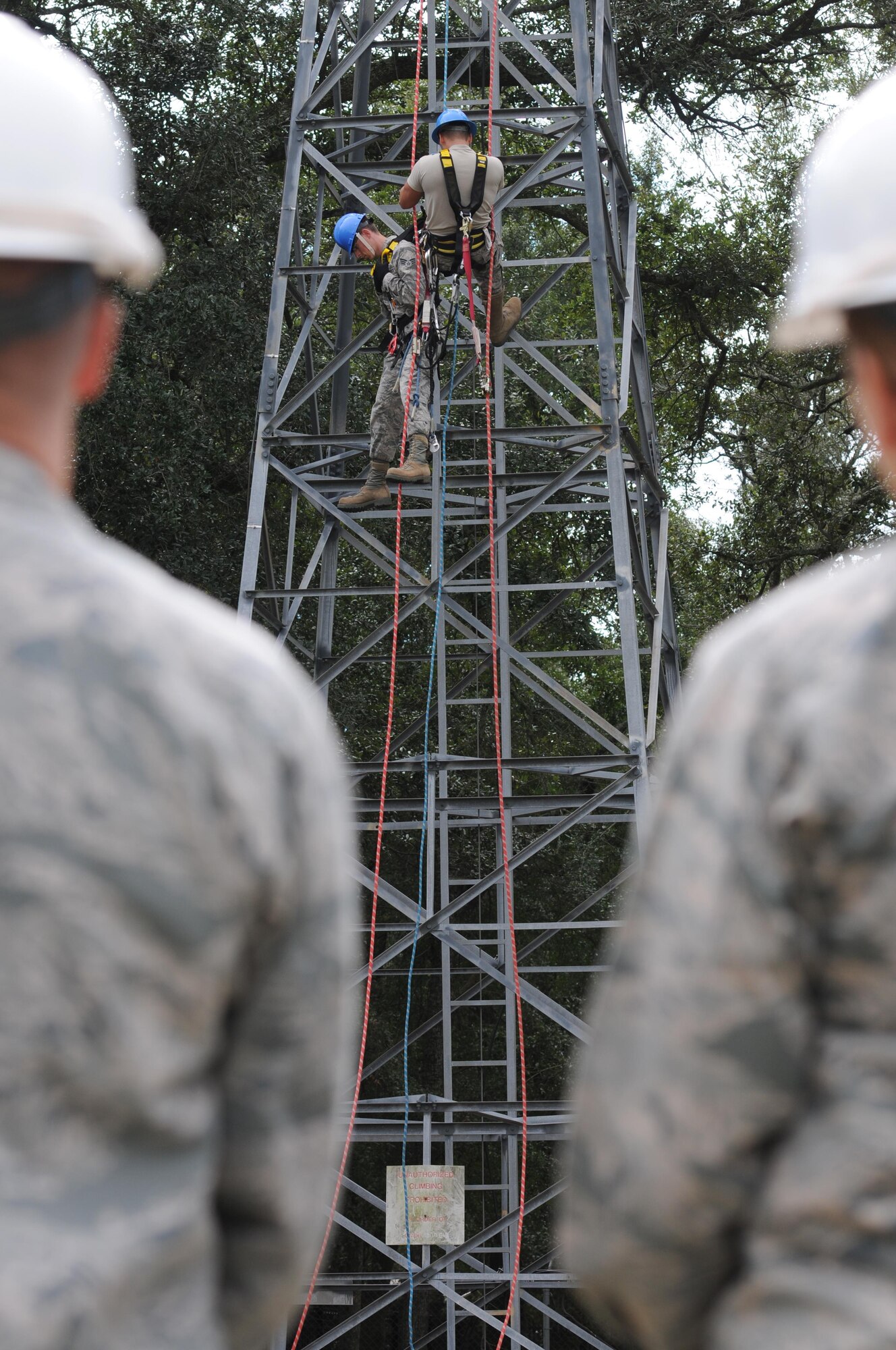 Senior Airmen Jeremy Goreczny and Joey Peay, 85th Engineering Installation Squadron cable and antennae technicians, provide a tower rescue demonstration to base leadership during the 85th EIS open house at Maltby Hall Nov. 3, 2015, Keesler Air Force Base, Miss. The open house also included a mission brief, a radiation hazards tour and an infrared camera demonstration. (U.S. Air Force photo by Kemberly Groue)