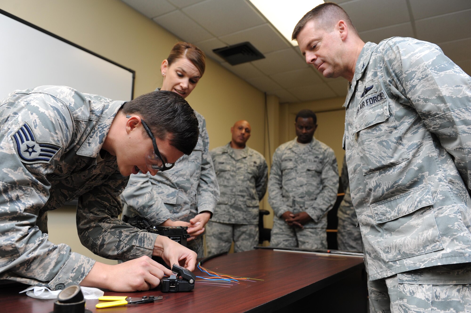 Staff Sgt. Anthony Terry, 85th Engineering Installation Squadron cable and antennae technician, provides a fiber optic splice hands-on demonstration to base leadership during the 85th EIS open house at Maltby Hall Nov. 3, 2015, Keesler Air Force Base, Miss. The open house also included a mission brief, tower rescue demonstration, radiation hazards tour and an infrared camera demonstration. (U.S. Air Force photo by Kemberly Groue)